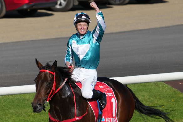 Winning jockey James McDonald salutes the crowd.