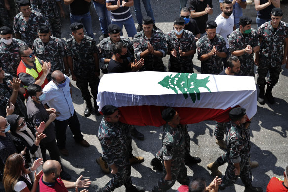 Firefighters carry the coffin of their comrade Rami Kaaki, one of 10 firefighters killed during the last week's explosion in Beirut.