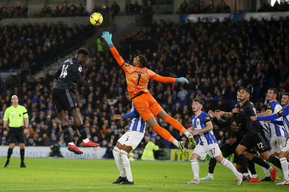 Robert Sanchez of Brighton & Hove Albion punches the ball away from Eddie Nketiah’