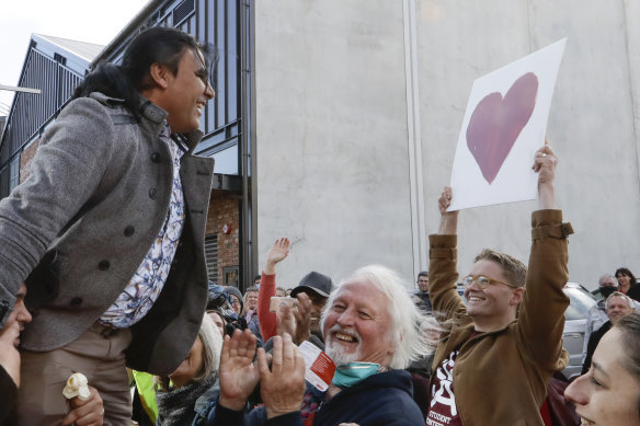 Mosque shooting survivor Abdul Aziz is held aloft as he thanks supporters outside the Christchurch High Court after Brenton Tarrant was sentenced to life without parole.