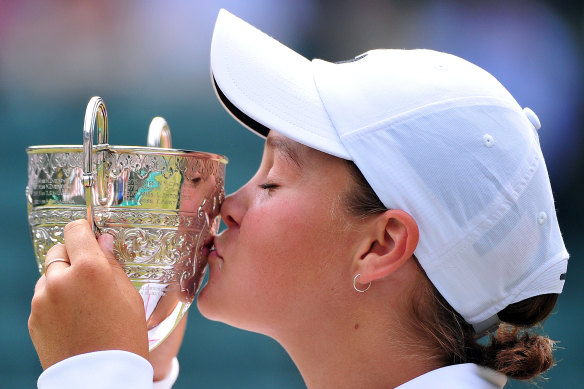 Ash Barty kisses the trophy after taking out the girls’ singles final at Wimbledon in 2011.