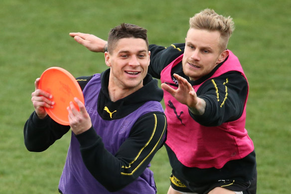 Dion Prestia and Brandon Ellis play keepings off with a frisbee at Richmond training on Sunday.