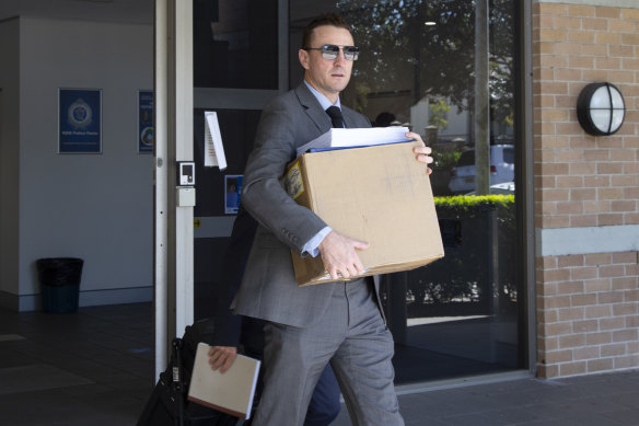 A detective leaves Wollongong police station after spending the morning interviewing Tristan Sailor.