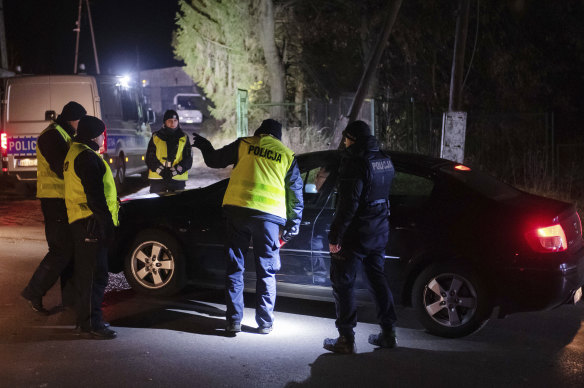 Police gather outside a grain depot in Przewodow, eastern Poland, where the Polish Foreign Ministry said Russian-made missiles fell and killed two people. 