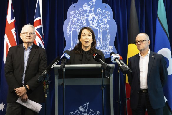 Emergency Services Minister Jaclyn Symes discusses the review into Victoria’s triple-zero operator system, with ESTA boss Stephen Leane (left) and review author Tony Pearce.