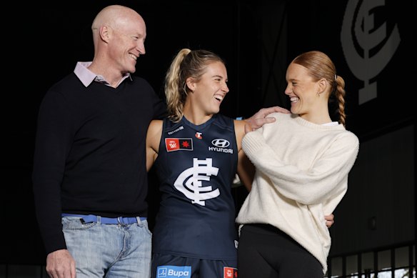 Carlton premiership player Andrew McKay with daughters Abbie, centre, and Sophie. 