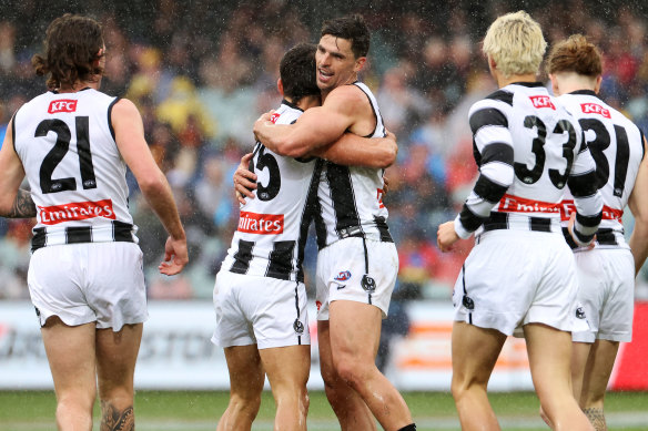Nick Daicos celebrates a goal, much to Scott Pendlebury’s approval.