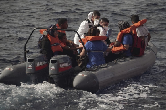 Members of the Maltese Armed Forces rescue a group of migrants in the Mediterranean Sea.