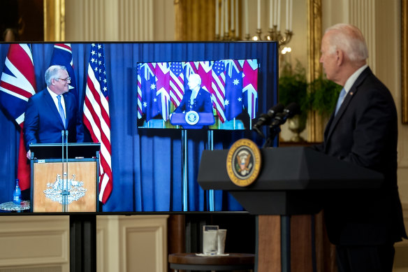 US President Joe Biden listens as Prime Minister Scott Morrison speaks via videoconference in the East Room of the White House.