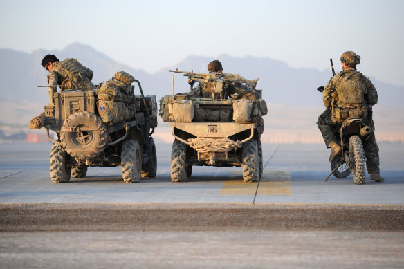 Special Air Service Regiment soldiers, part of the Special Operations Task Group in Tarin Kot, wait for a lift in a US helicopter to their patrol area in Afghanistan.