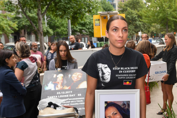 Daughters Apryl Watson and Kimberly Watson with photos of their mother Tanya Day outside the Coroners Court on Monday.