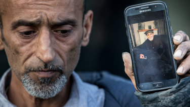 Omar Nabi, Yama's brother, holds a photo of their father, 71 year old Haji Daoud who was killed in the Masjid Al Noor Mosque in Christchurch.