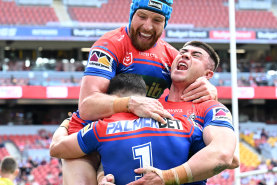 Jackson Hastings and Bradman Best celebrate David Armstrong’s (obscured) opening try.