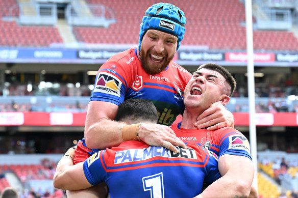 Jackson Hastings and Bradman Best celebrate David Armstrong’s (obscured) opening try.