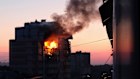 An apartment building burns after the attack.