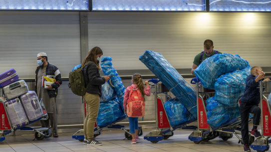 People line up to get on an overseas flight at the International Airport in Johannesburg.