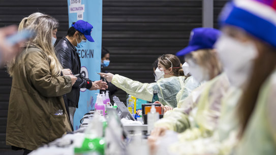 People check in at a vaccination hub at Whitten Oval on October 02, 2021 in Melbourne.