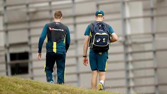 Walk on:  Steve Smith, left, and Cameron Bancroft talk at a training in Southampton on Monday and, inset,  facing the media in South Africa. Photos: Getty Images, AFP