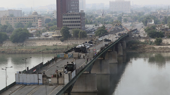 Security forces fire tear gas and close the bridge leading to the Green Zone during a demonstration in Baghdad, Iraq.