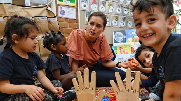 Pre-School teacher Tatiana Burmuzovski works through some basic number skills with children at Punchbowl Primary Pre-School