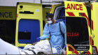A patient is taken from an ambulance outside St Thomas Hospital in London on Wednesday.
