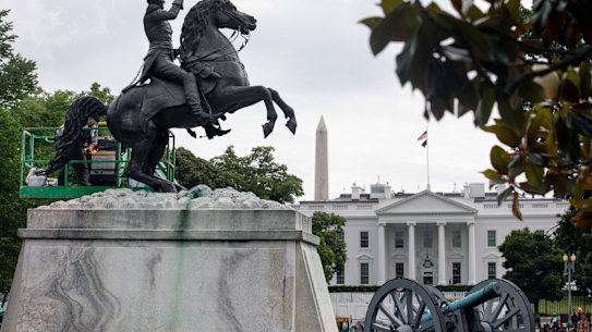 A worker cleans a statue of former US president Andrew Jackson near the White House. Protesters failed to bring it down on Monday.