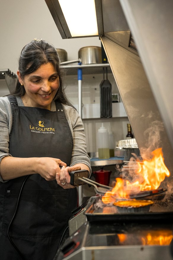 La Colmena owner Cristina Jimenez sears the top of a crema catalana.