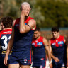 Skipper Max Gawn leads his beleaguered team off the field after their lamentable performance against Fremantle in Alice Springs.