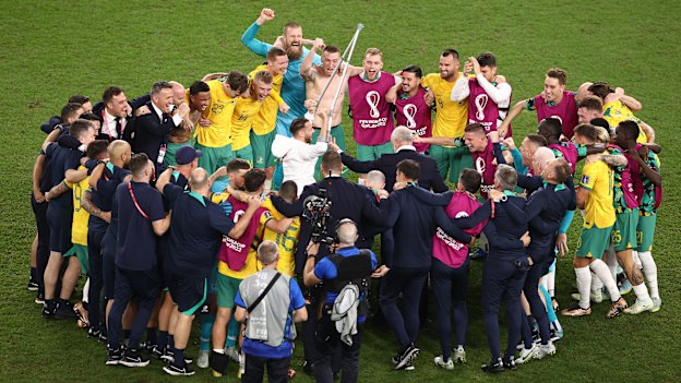 Graham Arnold and his team celebrate the historic win over Denmark.
