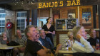 Soprano Katie Stenzel, at the bar, leads the audience in a singalong at Winton’s North Gregory Hotel.