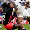 Fiji’s Josua Tuisova tackles England’s Manu Tuilagi in their Rugby World Cup quarter-final.