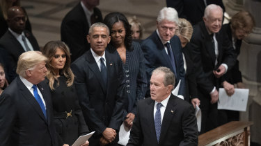 Former president George W. Bush walks to his seat after greeting President Donald Trump, first lady Melania Trump, former president Barack Obama, Michelle Obama, former president Bill Clinton, former secretary of state Hillary Clinton, former president Jimmy Carter and Rosalynn Carter during a state funeral for former president George H.W. Bush.