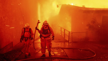 Firefighters battle the Camp Fire as it tears through Paradise.