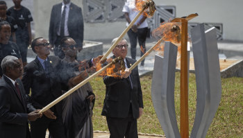 Chairperson of the African Union Commission Moussa Faki Mahamat, Rwanda's President Paul Kagame, Rwanda's first lady Jeannette Kagame, and President of the European Commission Jean-Claude Juncker light the flame of remembrance at the Kigali Genocide Memorial in Kigali on Sunday.  