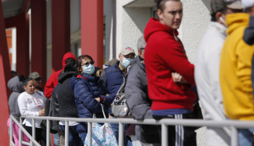 People wait in line to collect their unemployment benefits in Las Vegas.