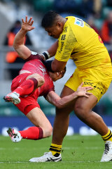 Antoine Dupont of Toulouse is tackled by La Rochelle’s Will Skelton.