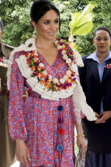 The Duchess of Sussex wore a silk Figue Frederica printed ruffle dress and a clutch bag of locally-made tapa barkcloth.