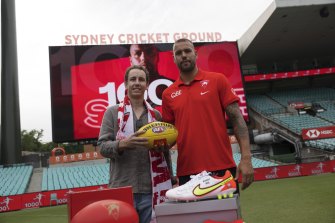 Sydney Swans fan Alex Wheeler giving back the 1000th goal ball to Lance Franklin this morning in Sydney.
