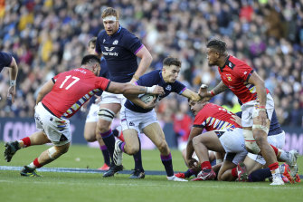 Scotland’s Jamie Dobie is tackled by Tonga’s Jethro Felemi.