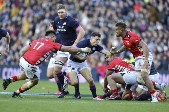 Scotlandâ€™s Jamie Dobie is tackled by Tongaâ€™s Jethro Felemi.