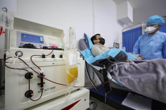 Dr Kong Yuefeng, a recovered COVID-19 patient, donates plasma in the blood centre in Wuhan. 
