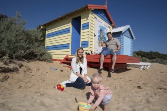 Estelle Graham, 18 months, in front of her family’s Brighton bathing box with parents Jenna and Matthew and five-year-old brother Angus.
