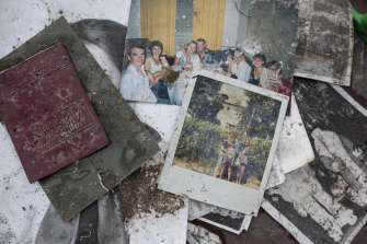 Photos and other personal items are scattered inside a destroyed apartment building in Borodianka.