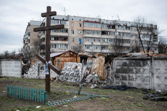 Damaged fence is seen behind a cross in Hostomel, Ukraine, near Kyiv. Hostomel was occupied for more than a month by Russian forces as they pushed toward the Ukrainian capital, before ultimately retreating to Belarus last week.