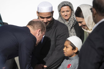 Prince William, left, meets a young Muslim and New Zealand Prime Minister Jacinda Ardern, second right, at the Al Noor mosque in Christchurch in six weeks after the attacks.