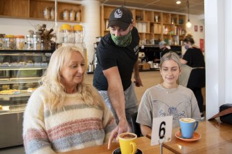 Beand Cafe owner Roy Farah serving coffees in  San Remo to Amanda Black and Louisa Pye.