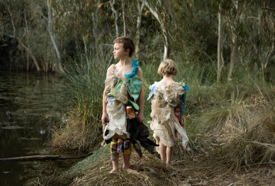 Photographer Daisy Noyes makes dresses out of rubbish she collects from the Merri Creek. She and her sons Marlow, 6, and Augie, 8, model them by the creek for her photo series on climate anxiety
