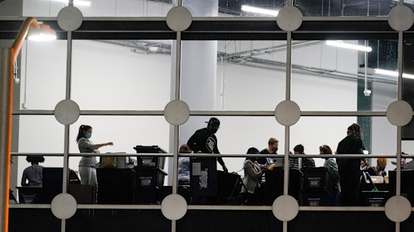 Election workers review absentee ballots in Fulton County. 