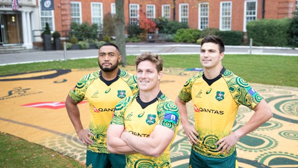 Honouring heritage: Sekope Kepu, Michael Hooper and Jack Maddocks stand in front of a supersized Wallabies Indigenous jersey in front of their team hotel in London. 