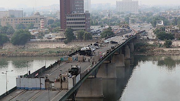 Security forces fire tear gas and close the bridge leading to the Green Zone during a demonstration in Baghdad, Iraq.